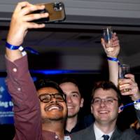 Grads raise glasses and take selfie